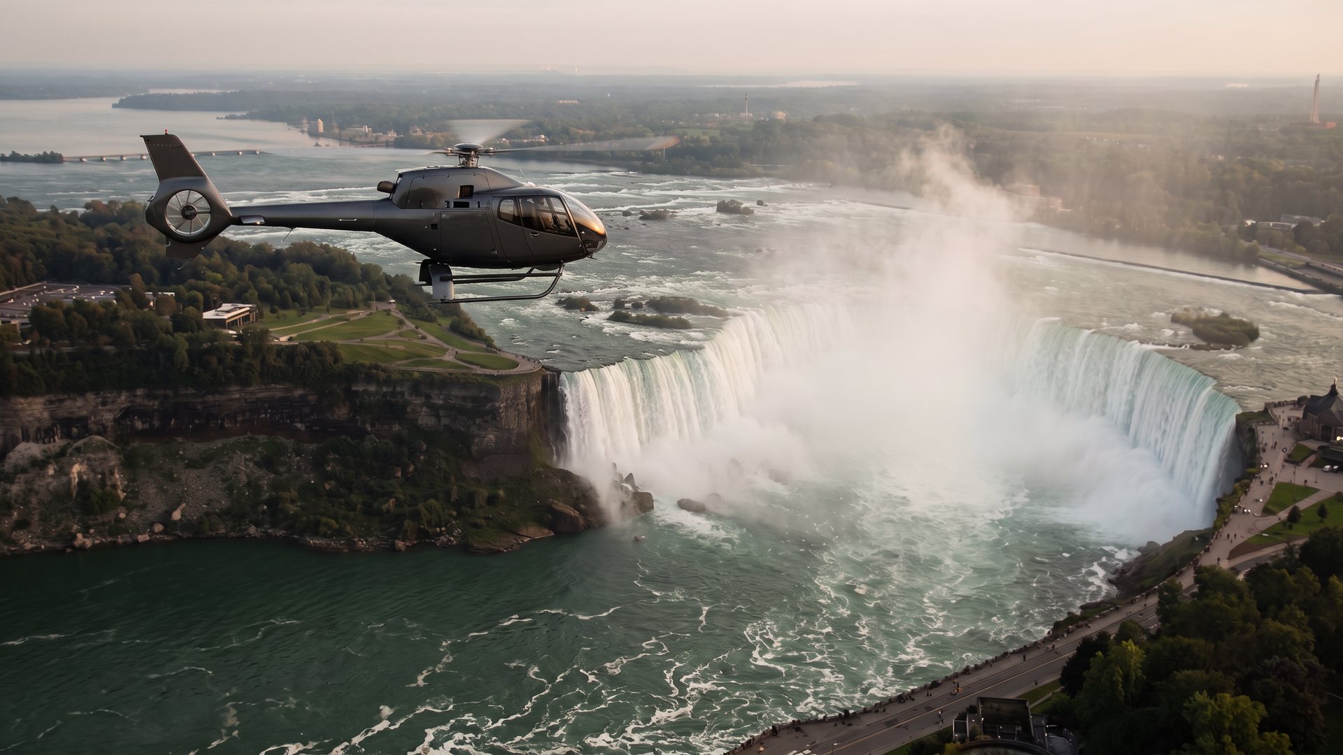 A dark grey sightseeing helicopter flying over the Horseshoe Falls, with mist rising from the gorge below